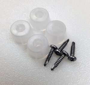 Four screws and four rubber feet neatly arranged on a table, designed for cutting board stability.
